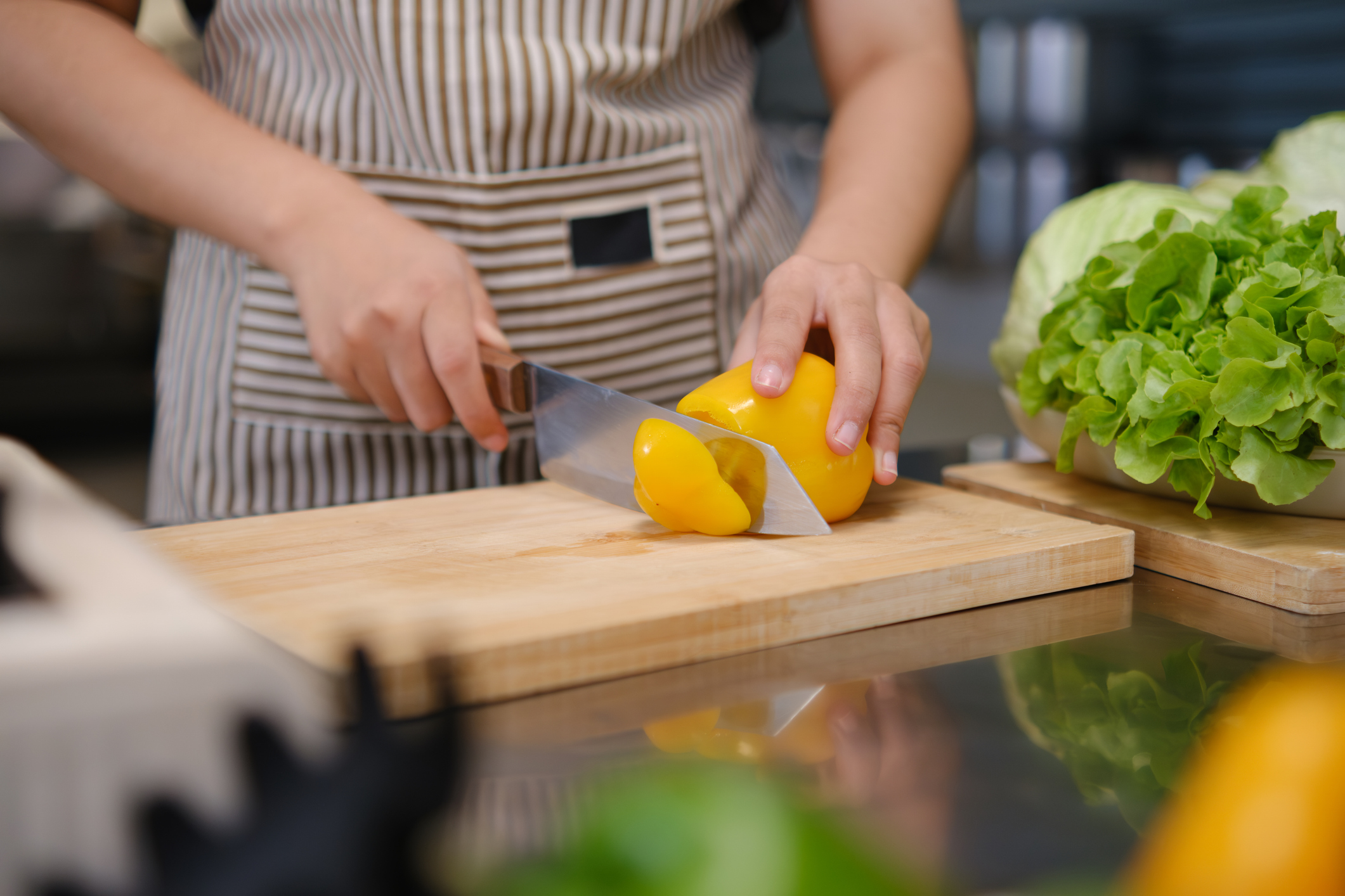 Making a Healthy and Nutritious Lunch: Hands of an Chef Woman Chopping Vegetables in the Kitchen